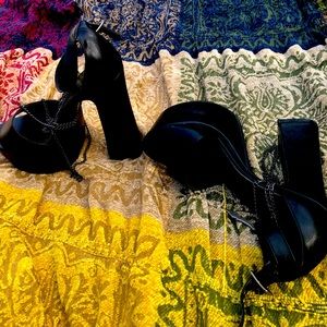 Black platform shoes with cross and chains